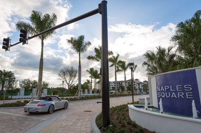 A motorist drives through a recently opened section of Third Street South in downtown Naples on Wednesday, Jan. 6, 2016. The recent downtown opening of Third Street South is being hailed by the city as a model for street design that includes parking, bike lanes, landscaping and sidewalks. (David Albers/Staff)